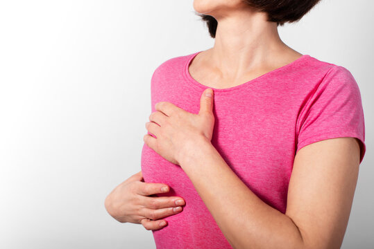 Middle aged caucasian woman doing breast self examination