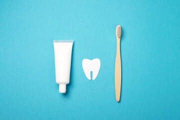 Bamboo toothbrushes, dental hygiene products on a blue background, copy space