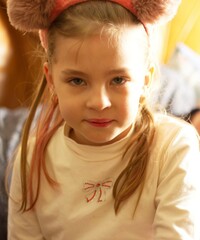 Beautiful preschool girl with loose hair with a headband on her head