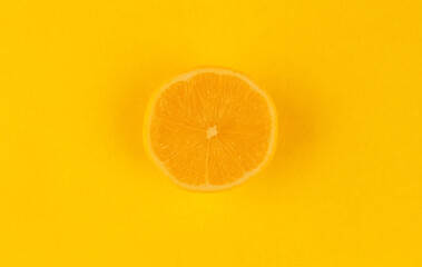 Yellow background with a round slice of lemon