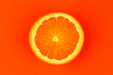 Round orange slice on orange background