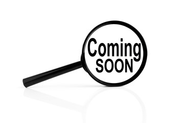COMING SOON. text inside the magnifier. magnifying glass on white background