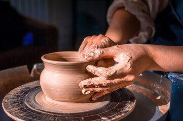 Young female potter working on a potter's wheel