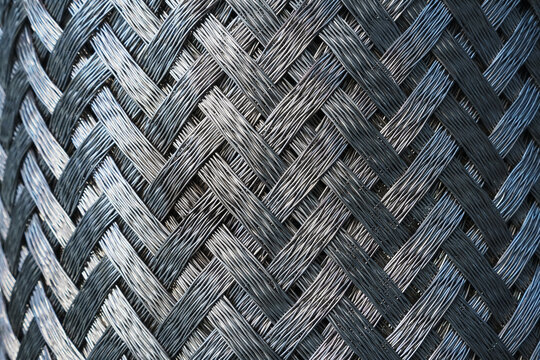 Metallic texture of steel herringbone weave close-up