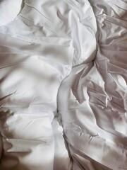 Top view of white bedding duvet crumpled at morning time