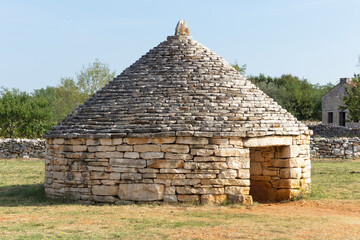 A Kazun is a native Mediterranean round house with conical roof. The house is built of dry stone without any other material. It is used as a shelter or for storage... - 472877920