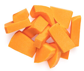 Sliced pumpkin pieces  isolated on white background. Diced Pumpkin cubes. Top view. Flat lay.