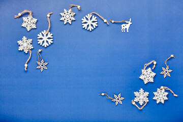 Christmas flatlay composition with wooden christmas decorations on greene background. Holiday card, Christmas greetings concept