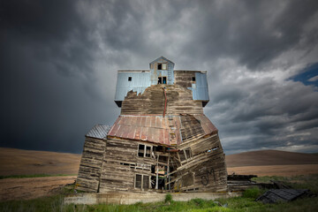 Old grain mill and storm clouds, Palouse region of eastern Washington.