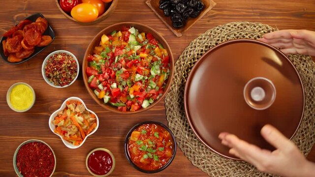 Moroccan cuisine top view. Tajine, traditional dish made of lamb and eggplant, vegetable salad. Middle eastern culture. Couscous with mutton close-up, delicious rice. Homemade food. 