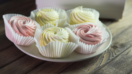 Food harmful to diabetics. Meringue on plate, close up, soft focus.
