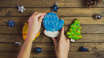 Holiday concept. Gingerbread in shape of Christmas mitten. Cookie on wooden background.