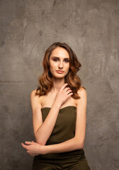 Fototapeta premium a model girl with New Year's makeup on a gray background with a place for text