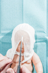 Baby Kopfverband Arbeitsschritt, demonstriert an einer Puppe