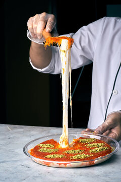 Arabian Traditional Desserts - Cream and cheeses with pistachio flavor and nuts topping on gray background
