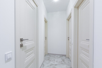 Interior of corridors in a large apartment with white walls