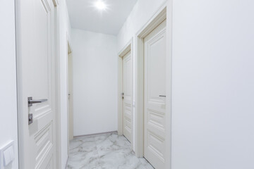 Interior of corridors in a large apartment with white walls