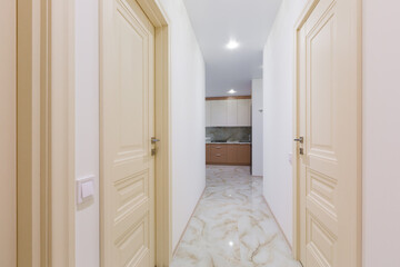 Interior of corridors in a large apartment with white walls