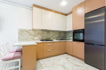 interior of a large kitchen with orange in a modern style