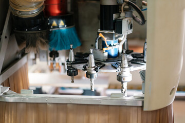 Cnc router grinding a part. Process of making cabinet furniture.
