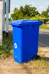 Blue  recycle bin at road side,  garbage bins in outdoor.