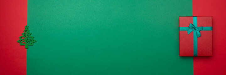 Festive background with toy in the form of Christmas tree and gift box. Christmas background with copyspace. Banner. Holiday concept