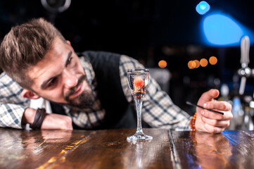 Barman formulates a cocktail in the brasserie