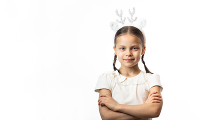 Portrait of smiling little girl in Christmas deer headband with two pigtails against white background