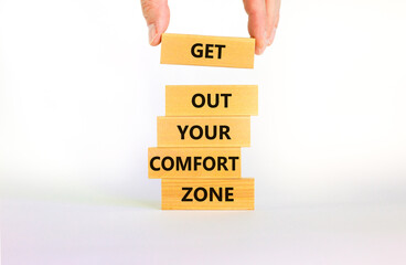 Get out your comfort zone symbol. Wooden blocks with words Get out your comfort zone on beautiful white background, copy space. Businessman hand. Business, out from comfort zone concept.