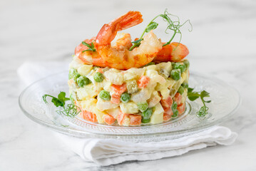 Christmas olivier salad with shrimps. Traditional Russian festive salad. Selective focus