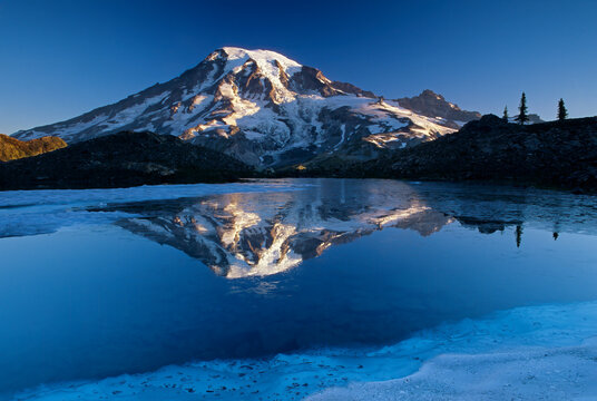 Washington State, Mount Rainier National Park, Tatoosh Range, Grinnell Glacier, Mount Rainier reflected in melt water pond
