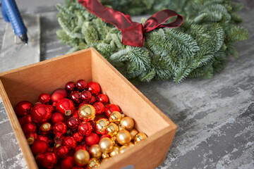 Manufacturer of Christmas wreath from branches of pine for holiday. Master class on making decorative ornaments. Christmas decor with their own hands. The new year celebration. Flower shop