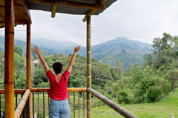 Horizontal view of unrecognizable woman sightseeing in Salento Valley. Horizontal panoramic view of woman traveling in Colombia jungle. People and travel destination in South America.
