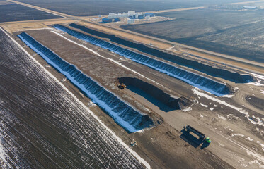 Aerial photo showing large rows of harvested sugar beets waiting to go to sugar beet factory, truck...