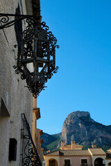 Fototapeta na wymiar White facade with wrought iron lantern in Polop village