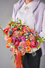 Beautiful large bouquet of mixed flowers without packaging. Handsome fresh bouquet in woman hand. Small flower shop and Flowers delivery.