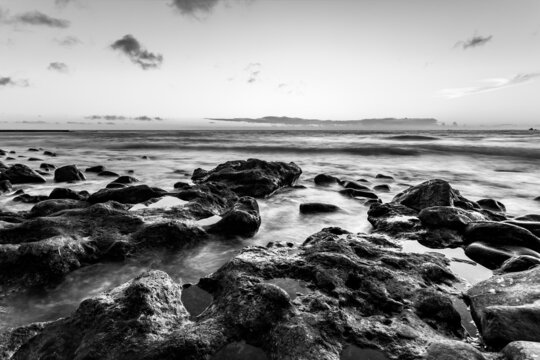 Black and white seascape with sunset over the Atlantic Ocean in Tenerife, Canary Islands, Spain. Long exposition