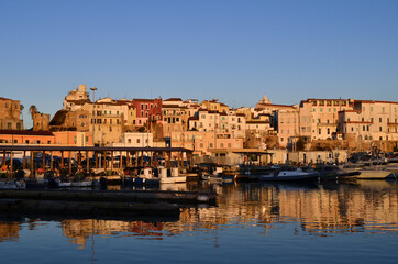 Fototapeta na wymiar Termoli - Molise - The houses overlooking the harbor and the small boats in the foreground.