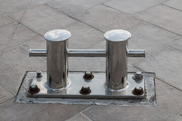 A bollard made of corrosion-resistant steel is installed on the pier of the seaport.