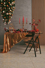 Christmas dining table in red and gold colors and inverted tree