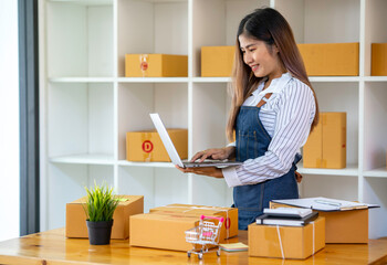 Small business, start-up business owners using computers at work, freelancers, saleswomen, checking production orders. Pack SME products for delivery to customers sell ecommerce delivery ideas