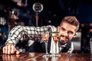 Expert bartending demonstrates the process of making a cocktail at the bar counter