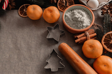 Ingredients for baking homemade cookies on on parchment. Baking ingredients background, Christmas baking ingredients and tolls for dough preparation. Christmas baking concept