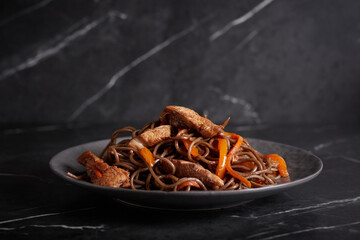 pasta with meat, spaghetti, noodles, plate on a dark background, asian cuisine