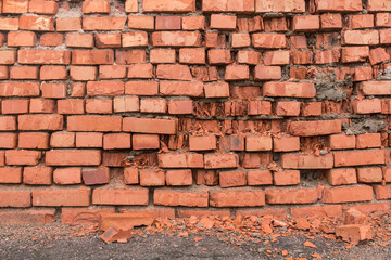 Old broken red or brown brick wall damaged ancient abandoned architecture
