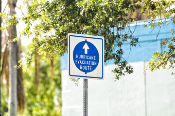 Hurricane evacuation route blue sign to shelter on road arrow direction in West Palm Beach, Florida...