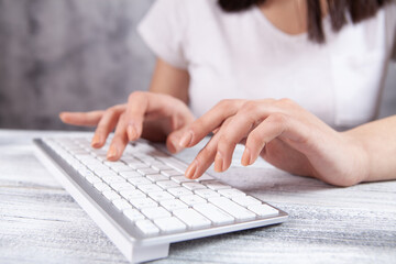 young woman typing on the keyboard