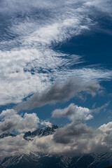 Cumulus clouds surround the Teton Mountains, Wyoming