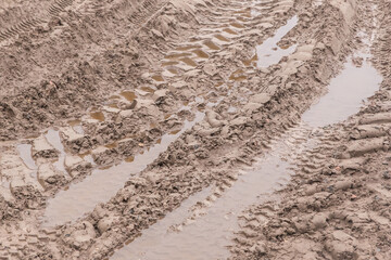Track pattern trail from vehicle on dirty sandy road soil from wheel texture background