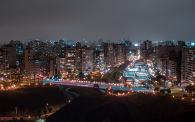 Fototapeta na wymiar Aerial night drone view over the bridge of Villena Rey from Miraflores District in Lima, Peru